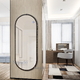 Full-length wall-mounted mirror with black frame