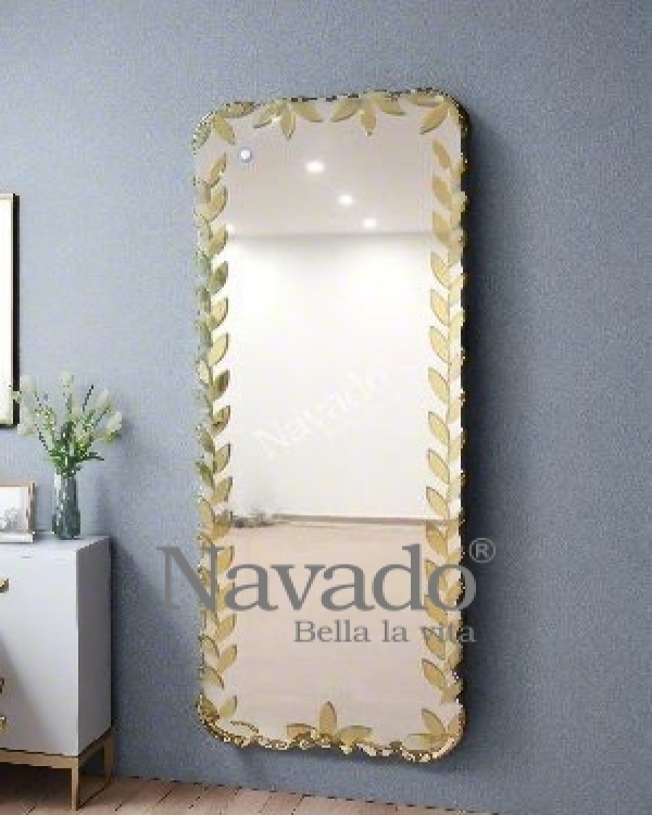 Full-length wall-mounted mirror with small pieces of art