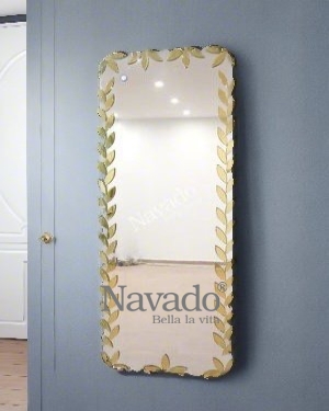 Full-length wall-mounted mirror with small pieces of art