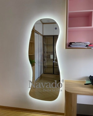 Full-length LED mirror mounted on the living room wall