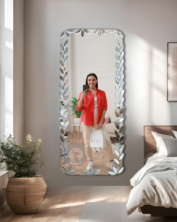 Full-length wall-mounted mirror with small pieces of art