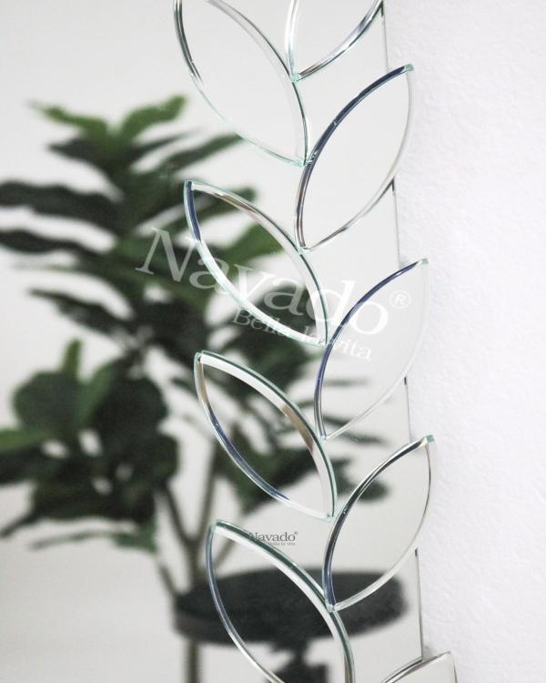 Full-length wall-mounted mirror with small pieces of art
