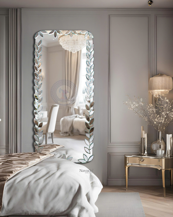 Full-length wall-mounted mirror with small pieces of art