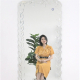 Full-length wall-mounted mirror with small pieces of art