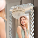 Full-length wall-mounted mirror with small pieces of art