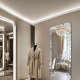 Full-length wall-mounted mirror with small pieces of art
